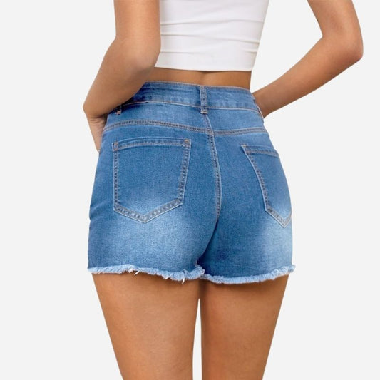 Women's ripped denim jeans shorts in blue, back view