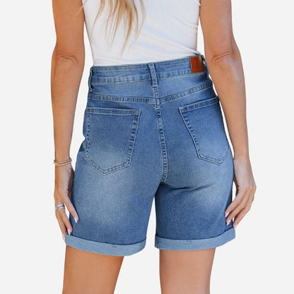 Women high waisted summer fold hem stretchy denim shorts in blue, back view