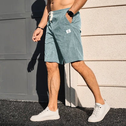 men's elastic waist drawstring summer beach shorts in blue, side view