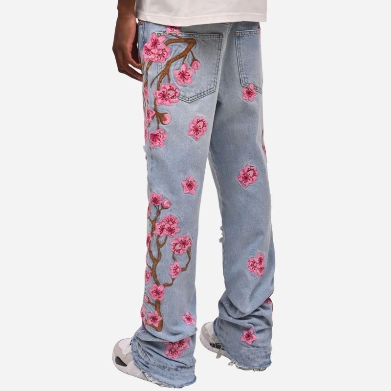 Men's graphic floral embroidered distressed straight leg denim jeans in light blue, back view
