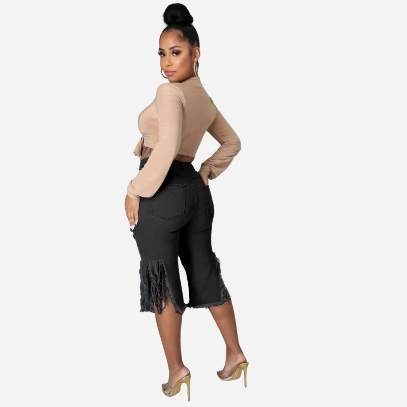 Women's high waisted ripped denim capri shorts raw hem chain distressed in black, back view