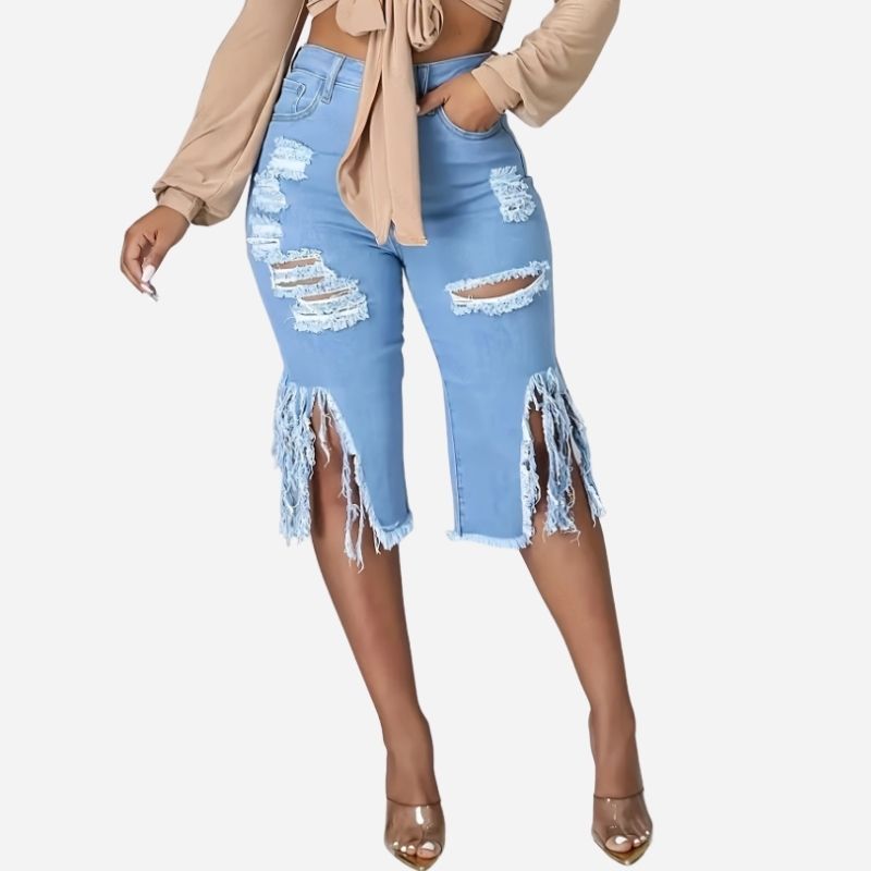 Women's high waisted ripped denim capri shorts raw hem chain distressed in blue, front view