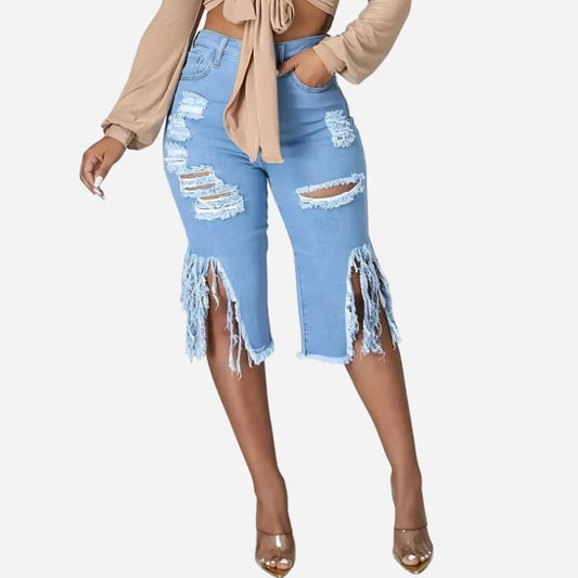 Women's high waisted ripped denim capri shorts raw hem chain distressed in blue, front view