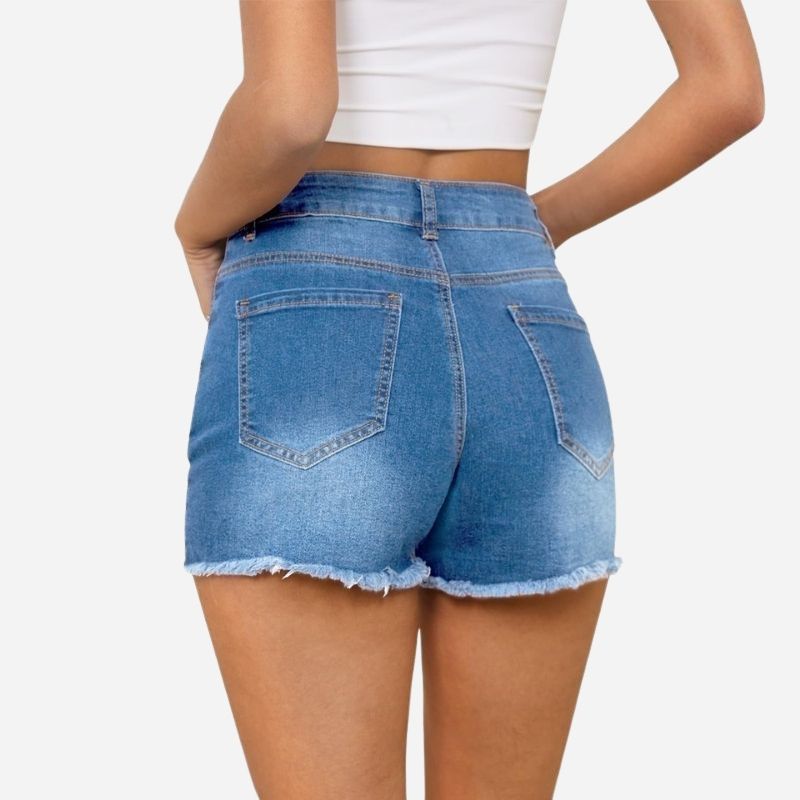 Women's ripped denim jeans shorts in blue, back view
